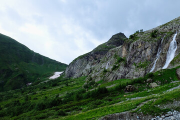 Beautiful view of the Caucasus mountains. In the background are waterfalls from the snowy peaks of the Caucasus.