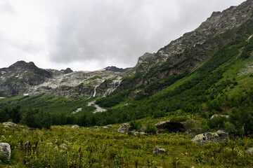 Beautiful view of the Caucasus mountains. In the background are waterfalls from the snowy peaks of the Caucasus.