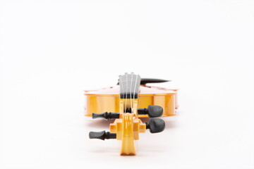 Wooden violins lie flat against a white background.