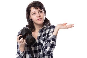 Young female freelance professional photographer or art student or photojournalist on a white background holding a camera. She is confused or shy