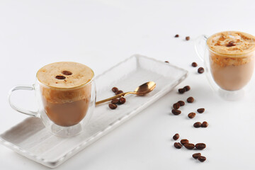 A delicious cup of coffee with coffee beans