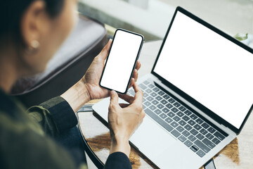 computer,cell phone mockup image.hand woman work using laptop texting mobile.blank screen with...