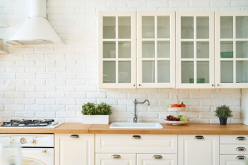 Fototapeta na wymiar Kitchen interior with kitchen utensils and kitchen stove. Scandi style.