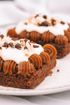 Chocolate Brownie Cake With Dulce De Leche And Cream On A Plate