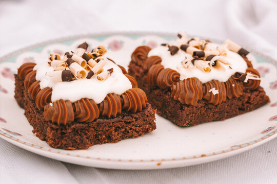 Chocolate Brownie Cake With Dulce De Leche And Cream On A Plate