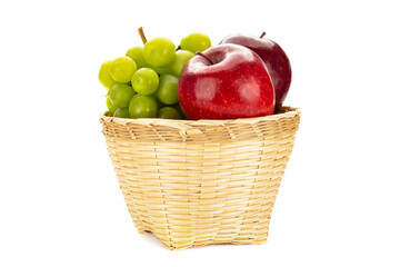 Green grapes and red in a weave bamboo basket.