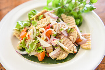 Spicy Vietnamese Sausage with salted egg with egg yolk and vegetable - Vietnamese pork sausage salad on a plate