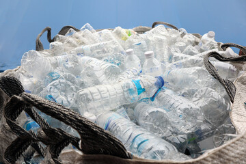 Used plastic bottles in a large sack for recycle.