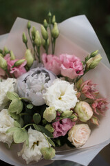 Perfect bouquet of flowers on black table near trees