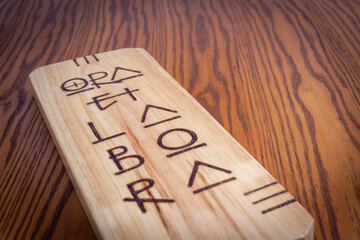 Religious latin phrase on wood