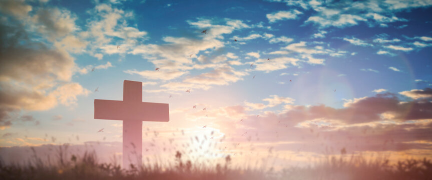 Silhouette jesus christ crucifix on cross on calvary sunset background concept for good friday he is risen in easter day, good friday worship in God, Christian praying in holy spirit religious.