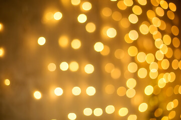 Bright Golden bokeh on the background of Christmas trees and garlands background New year and Christmas