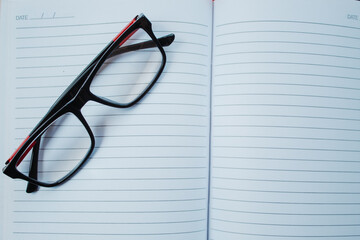 Glasses on top of the book