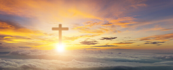 Conceptual wood cross or religion symbol over a sunset sky with clouds background for God. belief...