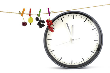 Clock with fresh fruit hanging on a line