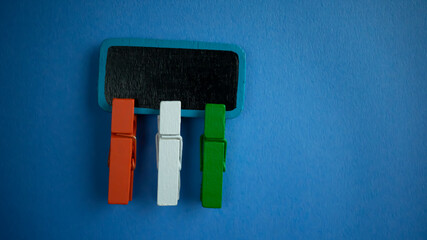 Orange white and green coloured wooden clip on white background to concept representation of Indian independence  