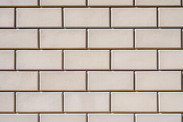 Background from a wall with rectangular beige stone slabs
