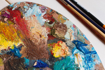 Obraz na płótnie Canvas Artist desktop with paints and brushes
