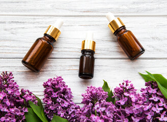 Essential oil and lilac flowers