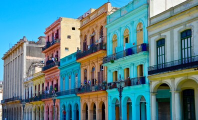 Havana, Cuba, colorful colonial houses, blue sky background, palm tree in front