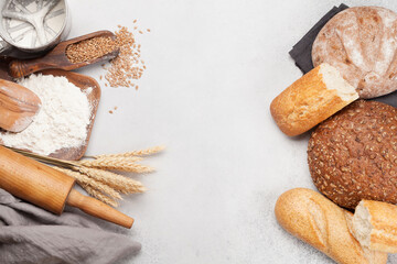 Fototapeta na wymiar Various bread with wheat, flour and cooking utensils