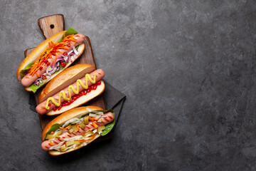 Various hot dog with vegetables, lettuce and condiments