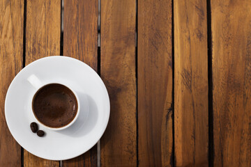 Cup of coffee on a wooden table on the mountain