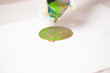 The girl creates a picture with abstraction in bright colors.