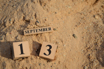September 13, Number cube with Sand pile for a background.