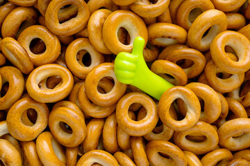 Sushki. Sushka. Ring-shaped bread products. Ttraditional Eastern European small, crunchy, mildly sweet bread rings. Toy hand folded as a sign is all good. View from above.