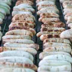 Many bananas grilled on the grill over the stove.