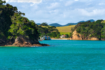 Beautiful seascape, Bay of Islands near Paihia, New Zealand, calm and relaxing harbour island with secret beach and turquoise clear water of Pacific ocean in the foreground