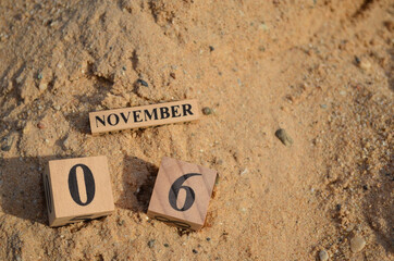 November 6, Number cube with Sand pile for a background.