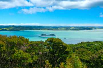 Beautiful seascape, Bay of Islands near Paihia, New Zealand, Big tourist cruise ship in the calm clear turquoise water of the harbour in small town of Russell