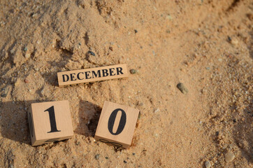 December 10, Number cube with Sand pile for a background.