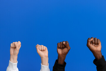 Caucasian woman and African-American man with clenched fists on color background. Racism concept
