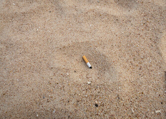 close up view of used cigarette butt left on sand ground , pollution , for background © RandomizeTH