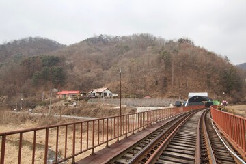 Fototapeta na wymiar Gangchon Rail Park, Chuncheon, South Korea - 15 February 2019: The rail cart for visitors to ride along old railroad tracks in the theme park. 