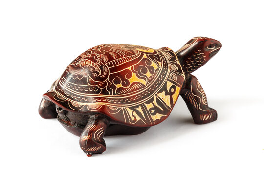 Tortoise with a Buddha image on a shell, isolated on a white background.