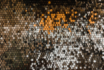 wall in sequins and sequins of gold and silver glamorous decoration of the interior of the...