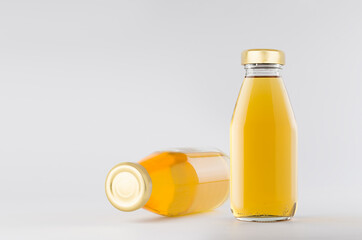 Yellow apple juices in glass bottles with gold empty cap for label mock up on white background with copy space, template for packaging, advertising, design product, branding.