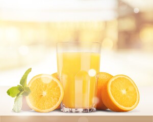 Orange juice and slices of orange on wooden desk