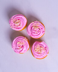 Beautiful pink cupcakes, cakes, arranged in the form of a rhombus, on a light background