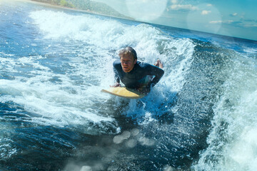 Surfer on Blue Ocean Wave Getting Barreled. 