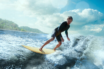 Surfer on Blue Ocean Wave Getting Barreled. 