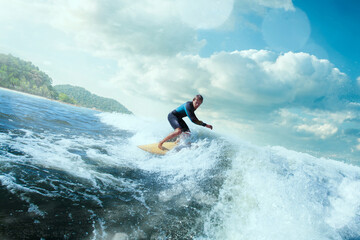 Surfer on Blue Ocean Wave Getting Barreled. 