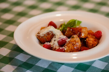 Beautiful juicy steak of marbled meat with raspberry sauce and seasonings.