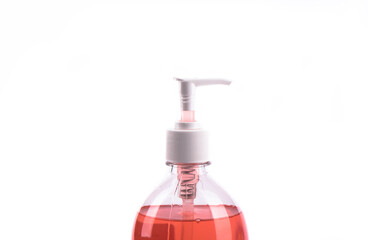 Red liquid soap in plastic pump bottle isolated on white background.