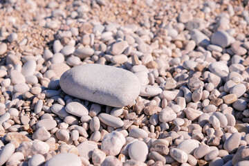 Pebbles on the beach. Stone on the shore. Copy space banner. Travelling, travel concept. Empty summer beach, tourism.