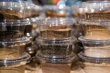 various spices and herbs packed in small transparent plastic boxes